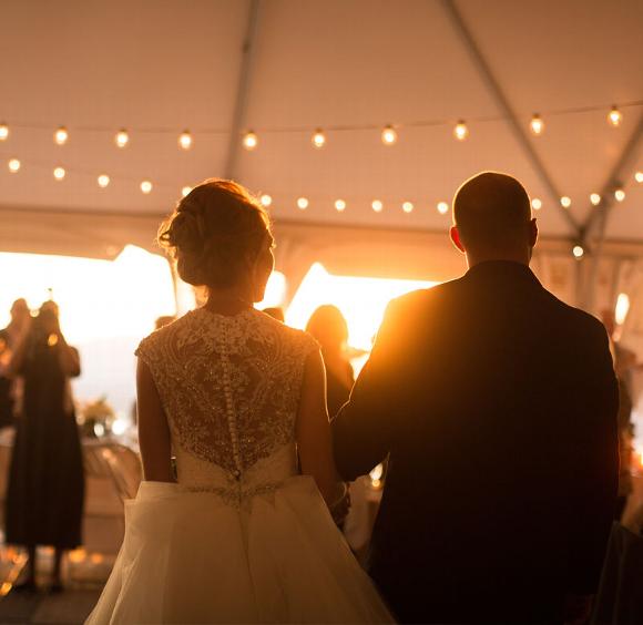 wedding couple in tent with guests