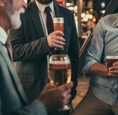 men in suits in pub drinking beer