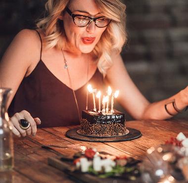 lady blowing out birthday candles